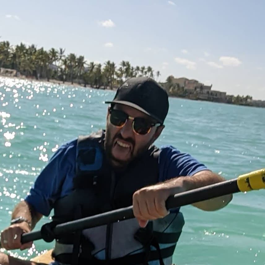 Zakk kayaking on bright blue water
